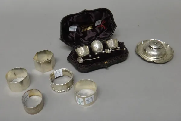 A Victorian silver three piece condiment set, comprising; a pepperette and a pair of salts, Sheffield 1888, with two associated salt spoons, with a ca