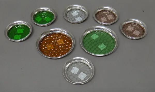 Six silver mounted moulded coloured glass coasters, each 8cm diameter and two larger silver mounted moulded coloured glass coasters, each 10.8cm diame