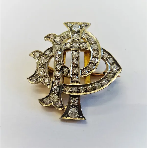 A diamond set brooch, designed as a monogram having the initials I.P.D, mounted with cushion shaped diamonds.