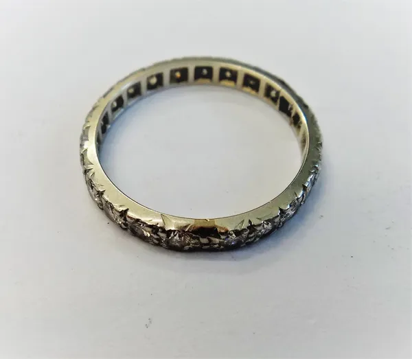 A diamond set full eternity ring, mounted with a row of circular cut diamonds, ring size N, with a case.