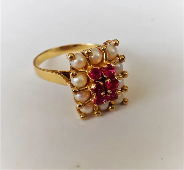 A gold, synthetic ruby and cultured pearl rectangular cluster ring, claw set with six circular cut synthetic rubies to the centre, within a surround o