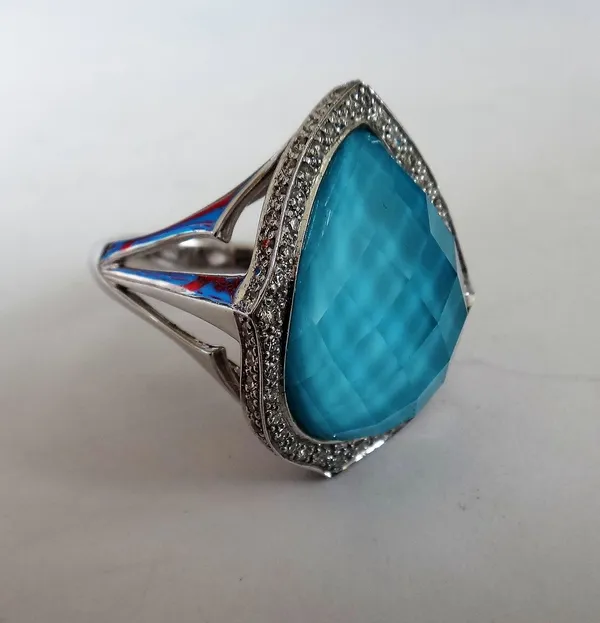 A Stephen Webster 'Haze' 18ct white gold and pale blue faceted gem set ring, the drop shaped faceted blue gem mounted within a surround of circular cu