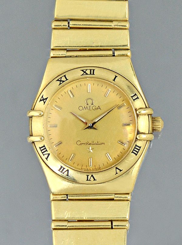 An Omega Constellation 18ct gold lady's bracelet wristwatch, the signed circular gilt dial with gilt baton shaped numerals, the bezel with black Roman