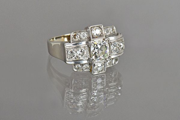 A white gold and diamond set cocktail style ring, mounted with the principal cushion shaped diamond to the centre and otherwise further set with small