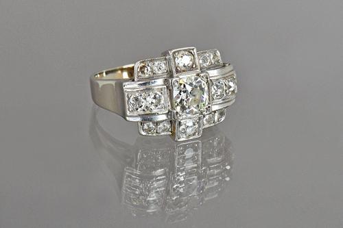 A white gold and diamond set cocktail style ring, mounted with the principal cushion shaped diamond to the centre and otherwise further set with small