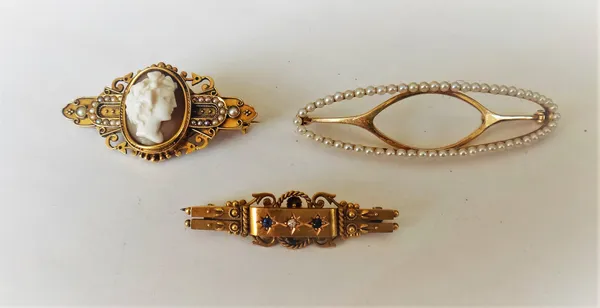 A Victorian gold, shell cameo and seed pearl set brooch, carved as the portrait of a lady between seed pearl set sides, a 15ct gold, sapphire and diam