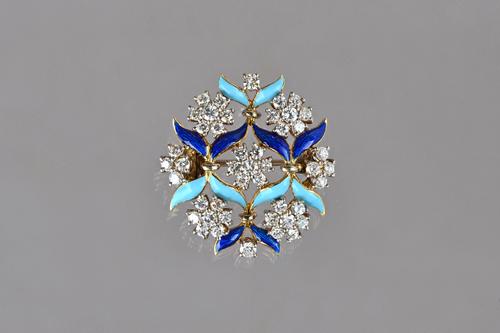 A gold, diamond and enamelled brooch, designed as a series of diamond clusters, mounted with circular cut stones and otherwise with light and dark blu