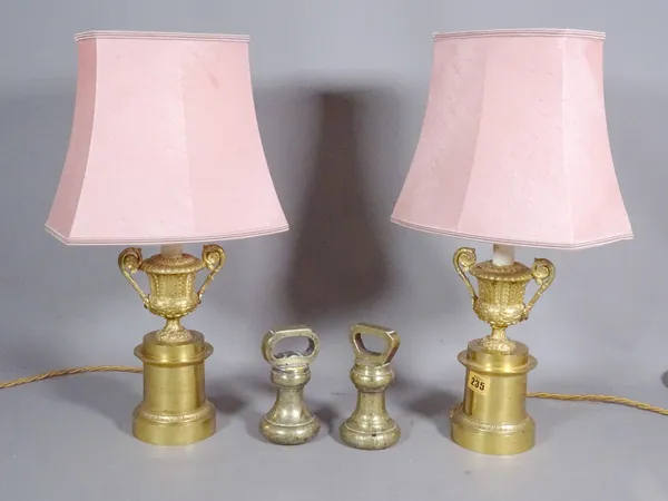 A pair of Empire style metal table lamps, formed as campana urns on cylindrical plinths, 23cm and a pair of 4lb brass weights.  S3M