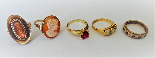 An 18ct gold ring, mounted with three oval opals and with diamonds at intervals (one diamond lacking), Birmingham 1905, a gold and oval shell cameo ri