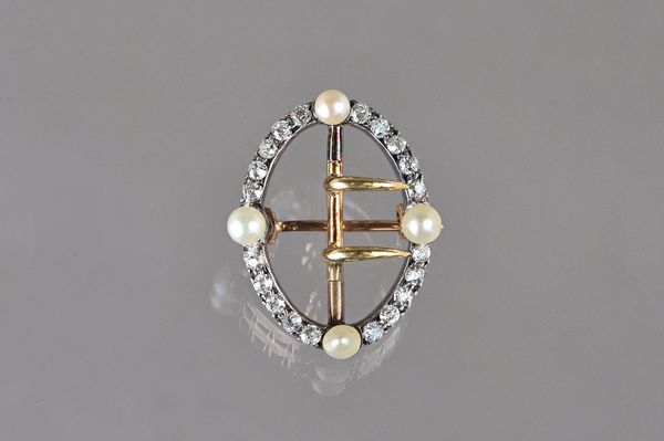 A Victorian diamond and cultured pearl brooch, in an oval openwork buckle design, mounted with cushion shaped diamonds and with four cultured pearls m