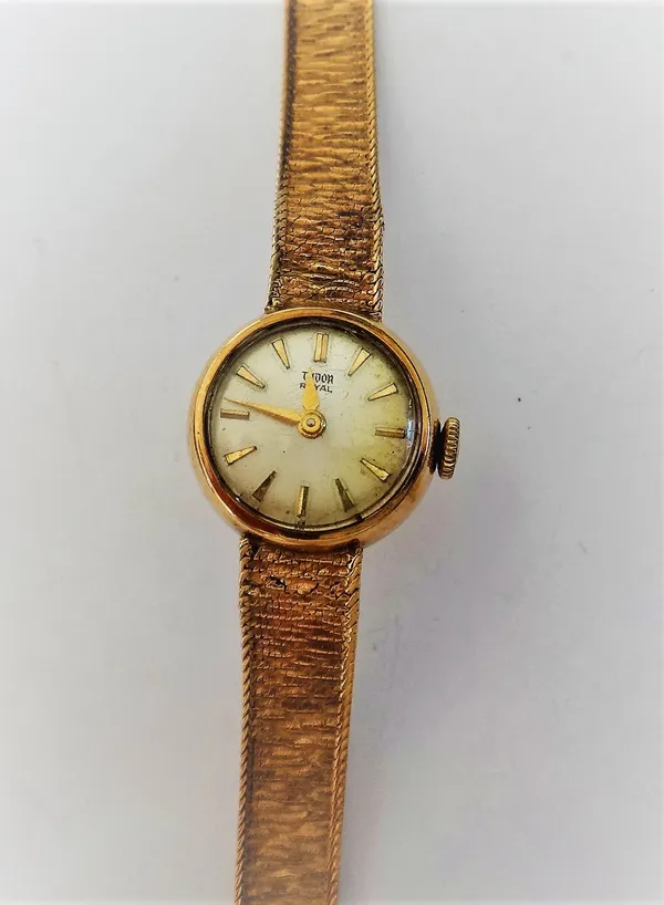 A Tudor Royal lady's 9ct gold bracelet wristwatch, the signed circular silvered dial with gilt baton shaped numerals, on a tapering textured link brac