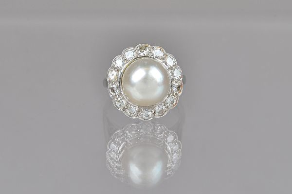 A white gold and platinum, cultured pearl and diamond cluster ring, mounted with the single cultured pearl at the centre, in a surround of circular cu