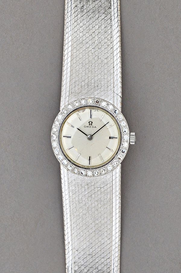 An Omega 18ct white gold and diamond set circular cased lady's dress wristwatch, with a signed jewelled movement, numbered 22090243, the signed silver