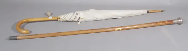 A 19th century silver topped cane, (a.f) and an early 20th century parasol, (2).   S3M