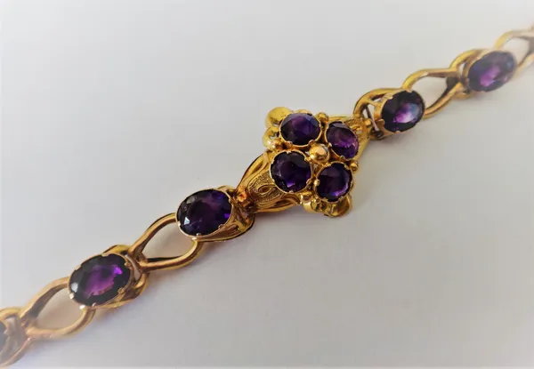 A Victorian gold and amethyst bracelet, the centre with a four stone cluster, mounted with cushion shaped amethysts, the links otherwise spaced with o