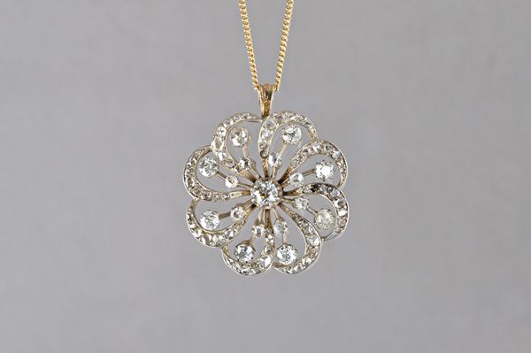 A diamond pendant, in a shaped circular scrolling design, mounted with cushion shaped and rose cut diamonds and with the principal diamond mounted at