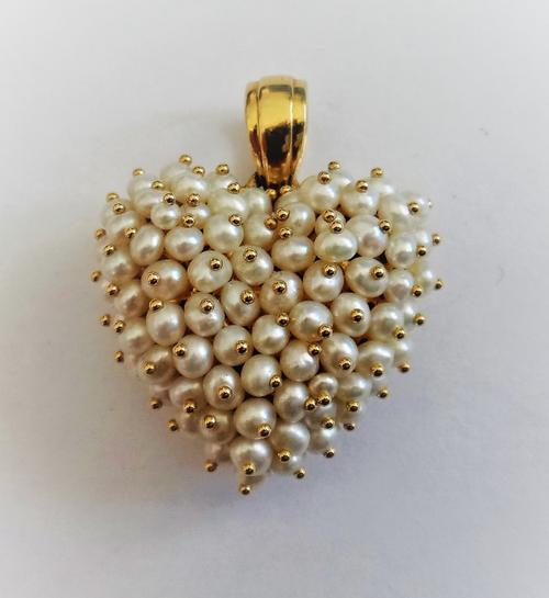 A gold and cultured pearl pendant, in a heart shaped design, the front mounted with cultured pearls, detailed to the back Le-Gi 750, gross weight 7.2