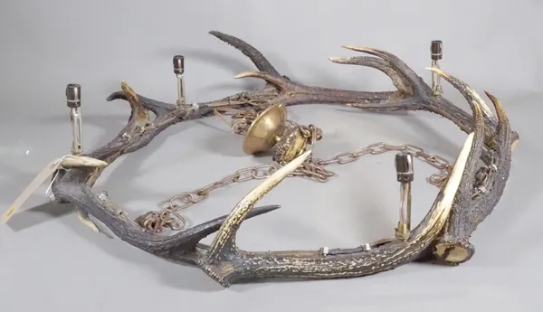 A 20th century chandelier formed from antlers, 64cm wide.    HANG