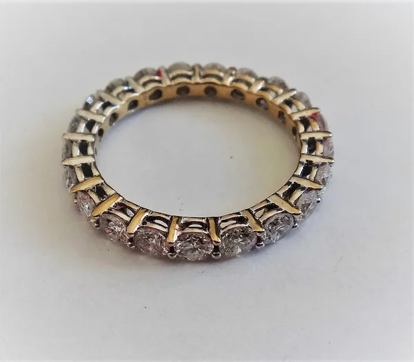 A white gold and diamond set full eternity ring, mounted with circular cut diamonds, detailed 750,  ring size L and a half.