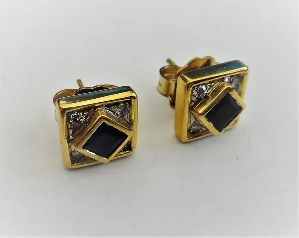 A pair of gold, sapphire and diamond earstuds, each of square form, mounted with a square cut sapphire to the centre, in a surround of four circular c