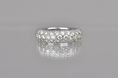 A Cartier white gold and diamond set half hoop ring, mounted with rows of circular cut diamonds, in a bombe design, detailed Cartier 750, ring size I