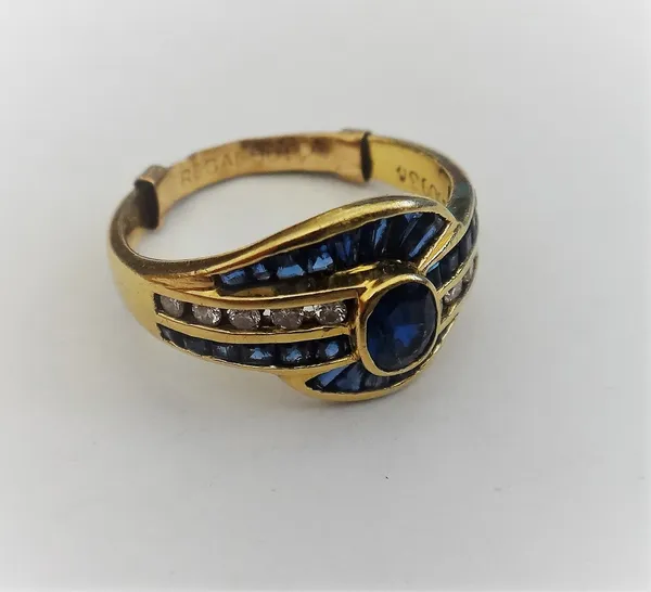 A gold, sapphire and diamond ring, in a spiral cluster design, collet set with the principal oval cut sapphire to the centre, between two rows of five