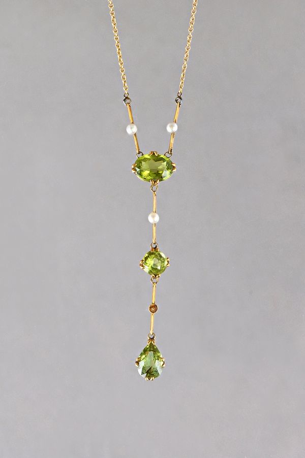 A gold, peridot and seed pearl pendant necklace, mounted with a pear shaped peridot to the drop, a circular cut peridot to the centre and with an oval