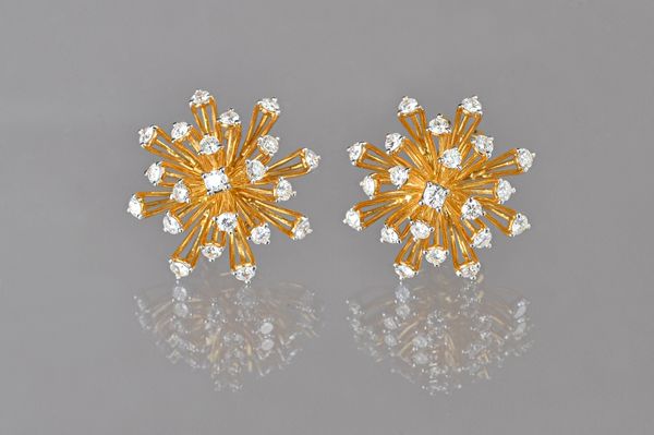 A pair of gold and diamond set earclips, each in an abstract starburst design, the backs with post and folding clip fittings, with a case, gross combi