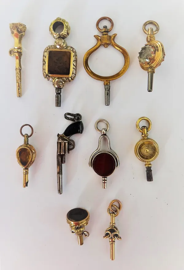 A mottled brown agate set gilt metal watch key, an agate set watch key, with a seal stone terminal, a novelty watch key, designed as a pistol and seve
