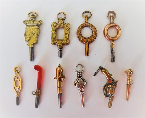 A brass mounted watch key, designed as the crowned portrait of King Edward VII, possibly produced to commemorate his coronation, a gold mounted watch