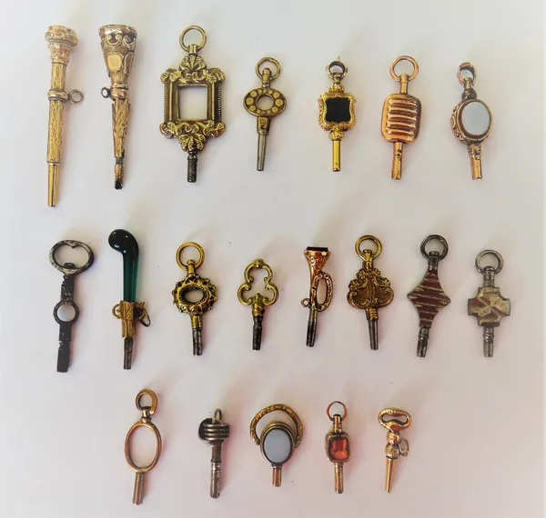 Two cut steel watch keys, a shield shaped bloodstone set watch key, a cornelian set watch key, modelled as a bugle and sixteen further mostly 19th cen