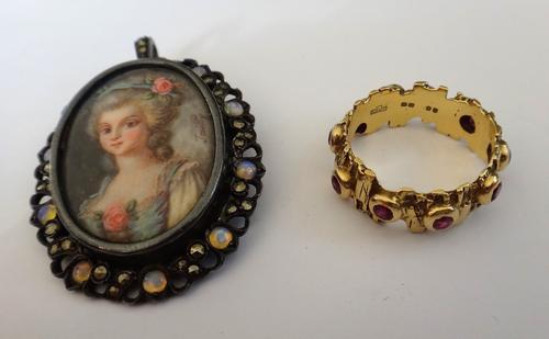 An 18ct gold and ruby stylized eternity ring, in a rustic design, collet set with circular cut rubies, London 1970, ring size Q, gross weight 6.8 gms