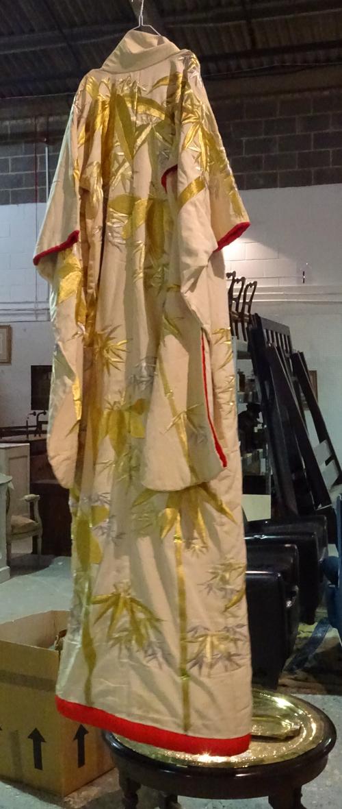 A Japanese wedding kimono, 20th century, worked in gold and silver thread with bamboo against a cream ground, 190cm length.  HANG