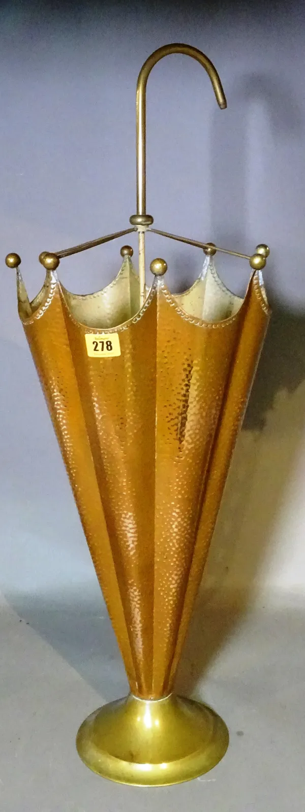 An early 20th century beaten copper stick stand formed as an umbrella, 78cm high.   G3