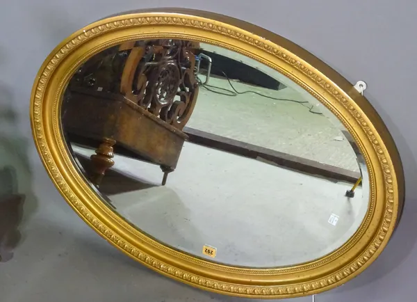 An oval gilt wall mirror, 62cm wide.   A9