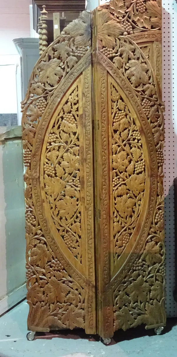 A 20th century carved hardwood three fold arch top screen, 148cm wide x 188cm high.  G10