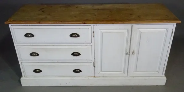 A rectangular white painted pine side cabinet, the pair of cupboard doors flanked by three drawers, 130c wide x 65cm high.  J5