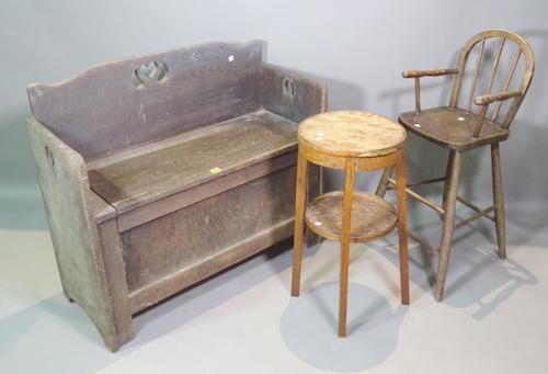 An early 20th century oak Art Nouveau settle, a child's high chair and a 20th century oak circular stool, (3).   C9