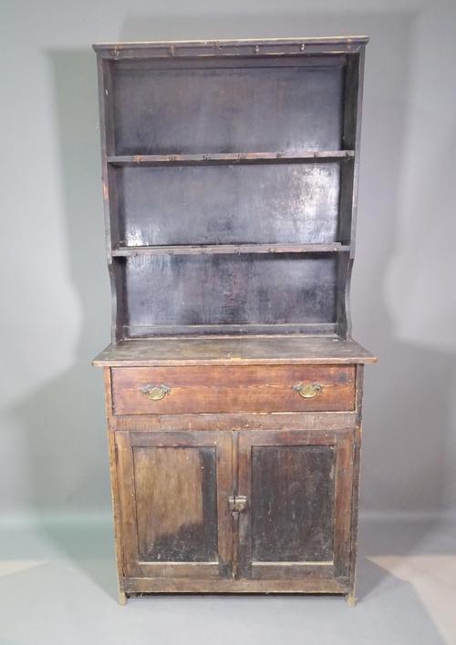 An early 20th century stained pine dresser with one drawer over cupboard base and three tier plate rack, 91cm wide x 198cm high.   L8