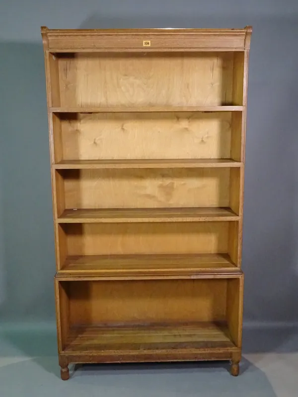 A 20th century oak four tier open bookcase on tapering supports, 89cm wide x 165cm high.   H10