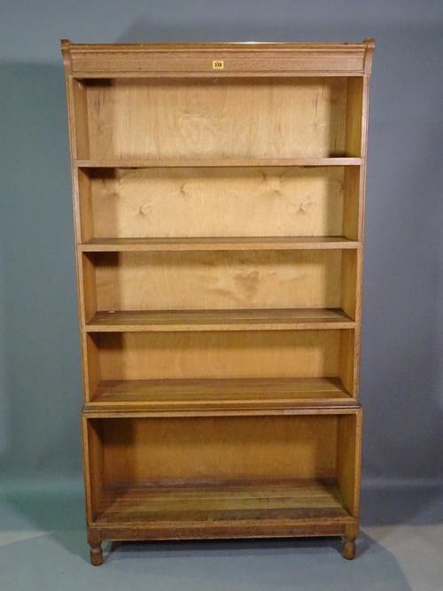 A 20th century oak four tier open bookcase on tapering supports, 89cm wide x 165cm high.   H10