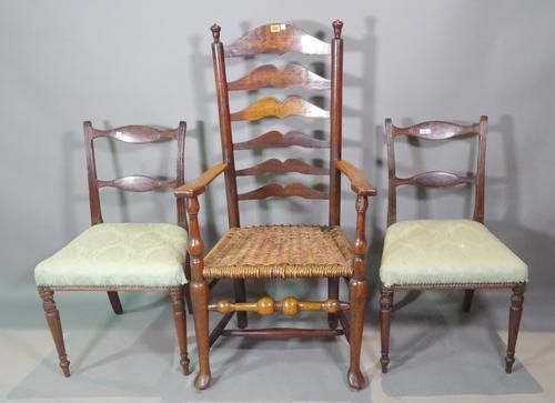 An early 19th century American cherry wood ladder back, open armchair and a pair of Regency mahogany bar back dining chairs, (3). G6