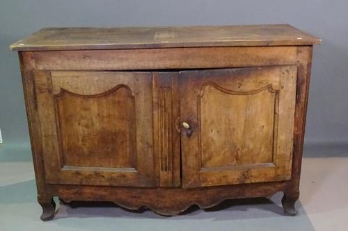 An early 19th century French walnut side cabinet with pair of panelled doors on squat cabriole supports, 138cm wide x 90cm high.   BAY 3