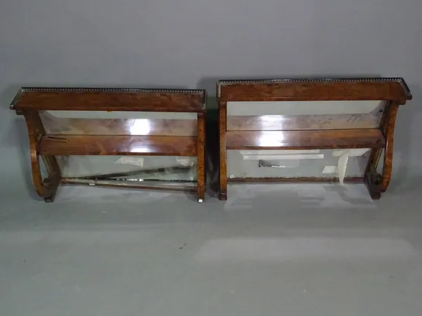 A pair of early 20th century yew wood two tiered mirrored back shelves, 85cm wide x 63cm high and a similar base lacking top, 115cm wide x 65cm high a