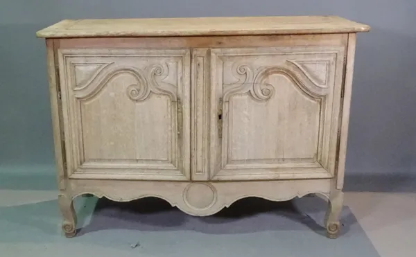 A French oak side cabinet with inset carved panel doors, 140cm wide x 90cm high.   BAY 2