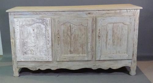 A 19th century French limed oak sideboard with three panelled doors, 175cm wide x 95cm high.   BAY 2