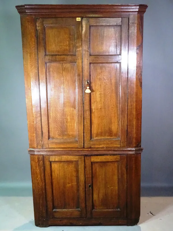 A 19th century oak floor standing corner cabinet, 105cm wide x 197cm high.  M10