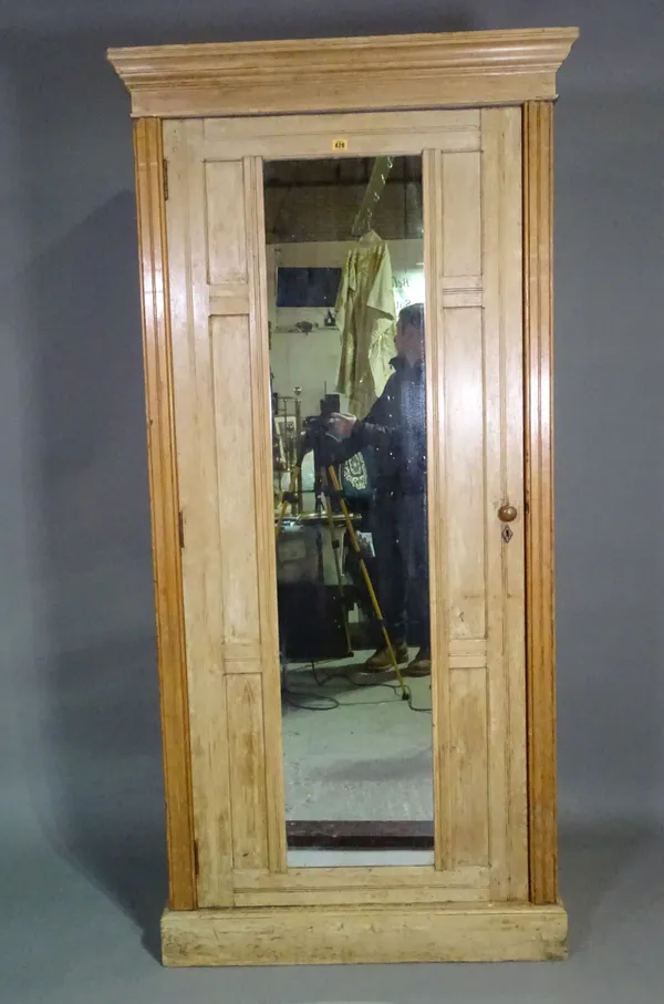 An early 20th century pine wardrobe with single mirrored door, on plinth base, 90cm wide x 190cm high.   M7