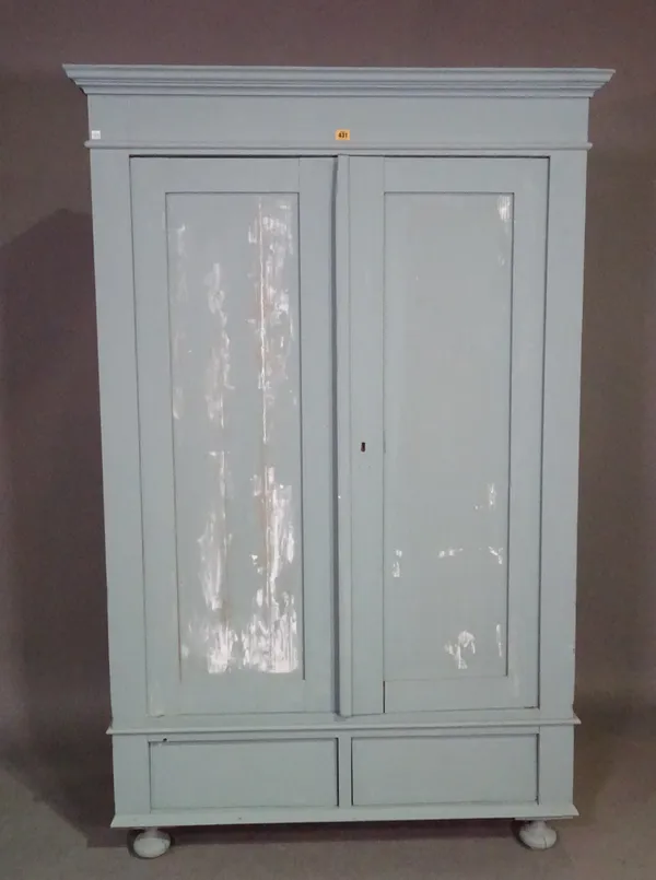 A 20th century grey painted two door wardrobe on bun feet, 117cm wide x 172cm high.   M6