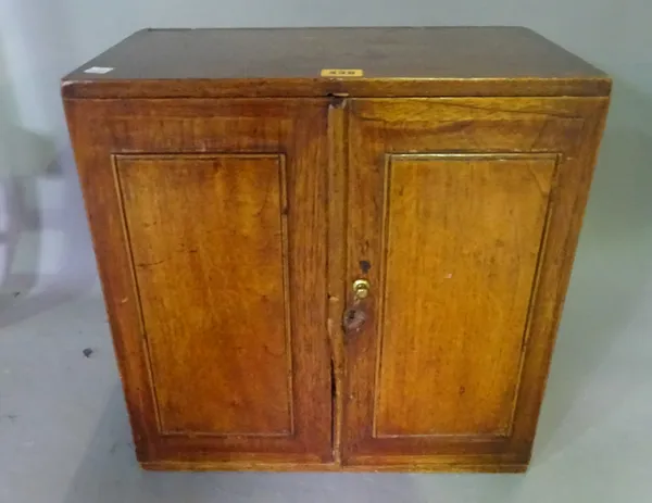 A 19th century oak table top cabinet with pair of doors, 41cm wide.   J9